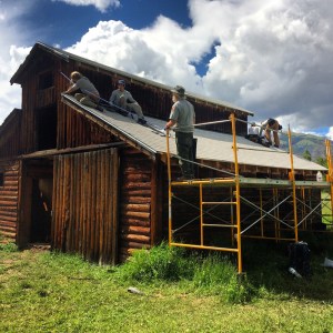 Crew members replacing the shingles on the Little Buckaroo Barn